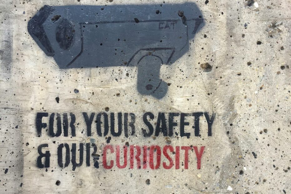 Security camera stencil with text on wall